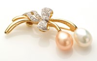 Lot 719 - A diamond, cultured pearl and 18ct. yellow...