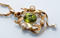 Lot 739 - An Edwardian peridot and seed pearl drop...