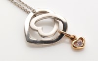 Lot 767 - A pink diamond set heart pattern drop pendant,...