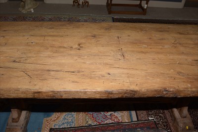 Lot 1165 - A substantial rustic oak dining table.
