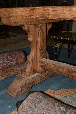 Lot 1165 - A substantial rustic oak dining table.