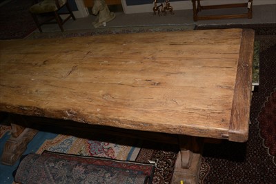 Lot 1165 - A substantial rustic oak dining table.