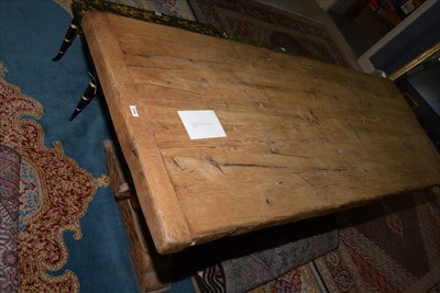 Lot 1165 - A substantial rustic oak dining table.