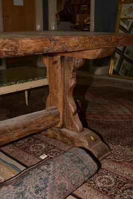 Lot 1165 - A substantial rustic oak dining table.