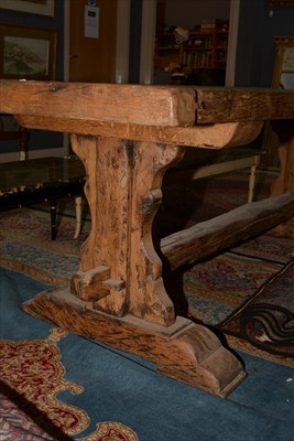 Lot 1165 - A substantial rustic oak dining table.