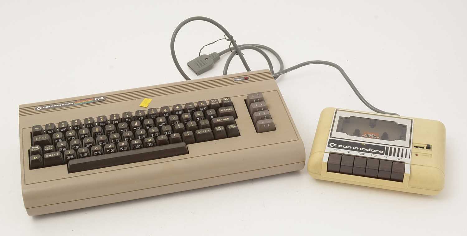 Lot 271 - A Commodore 64 home computer, with a cassette player and a selection of cassette games.