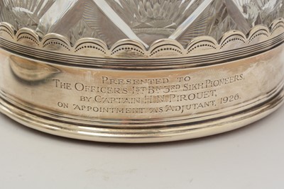 Lot 19 - A pair of George V silver wine coasters; together with a pair of cut glass decanters and stoppers