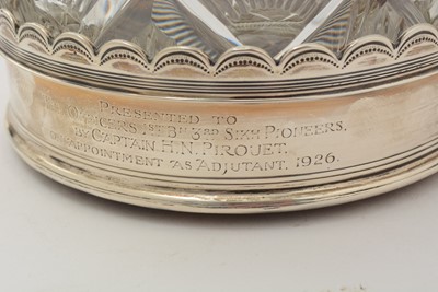 Lot 19 - A pair of George V silver wine coasters; together with a pair of cut glass decanters and stoppers