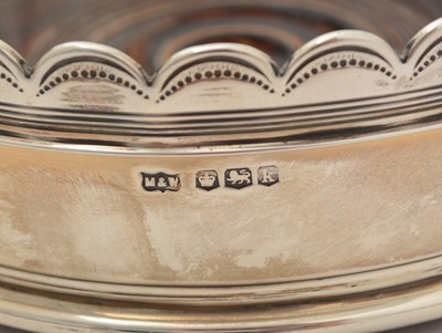 Lot 19 - A pair of George V silver wine coasters; together with a pair of cut glass decanters and stoppers