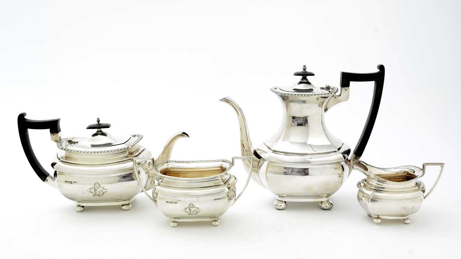 Lot 52 - An Edwardian three piece silver tea set and matching coffee pot