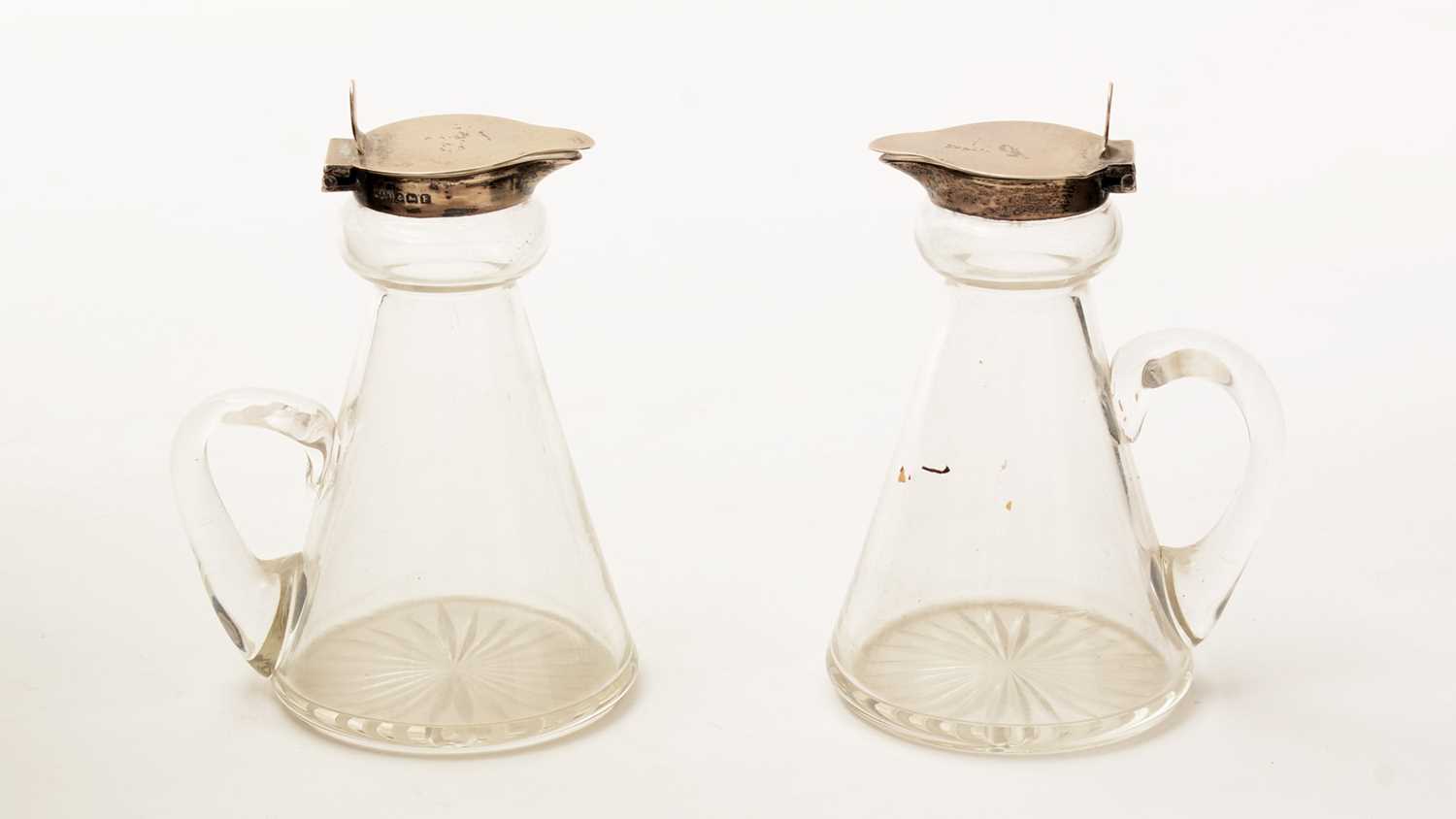 Lot 12 - A pair of George V silver-mounted clear glass whisky tots or chota pegs