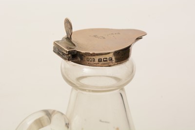 Lot 12 - A pair of George V silver-mounted clear glass whisky tots or chota pegs