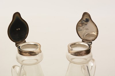 Lot 12 - A pair of George V silver-mounted clear glass whisky tots or chota pegs