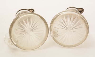 Lot 12 - A pair of George V silver-mounted clear glass whisky tots or chota pegs