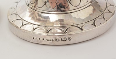 Lot 37 - A pair of George V arts and crafts silver vases with flaring rims