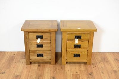 Lot 18 - A pair of contemporary oak furniture land style bedside cabinets