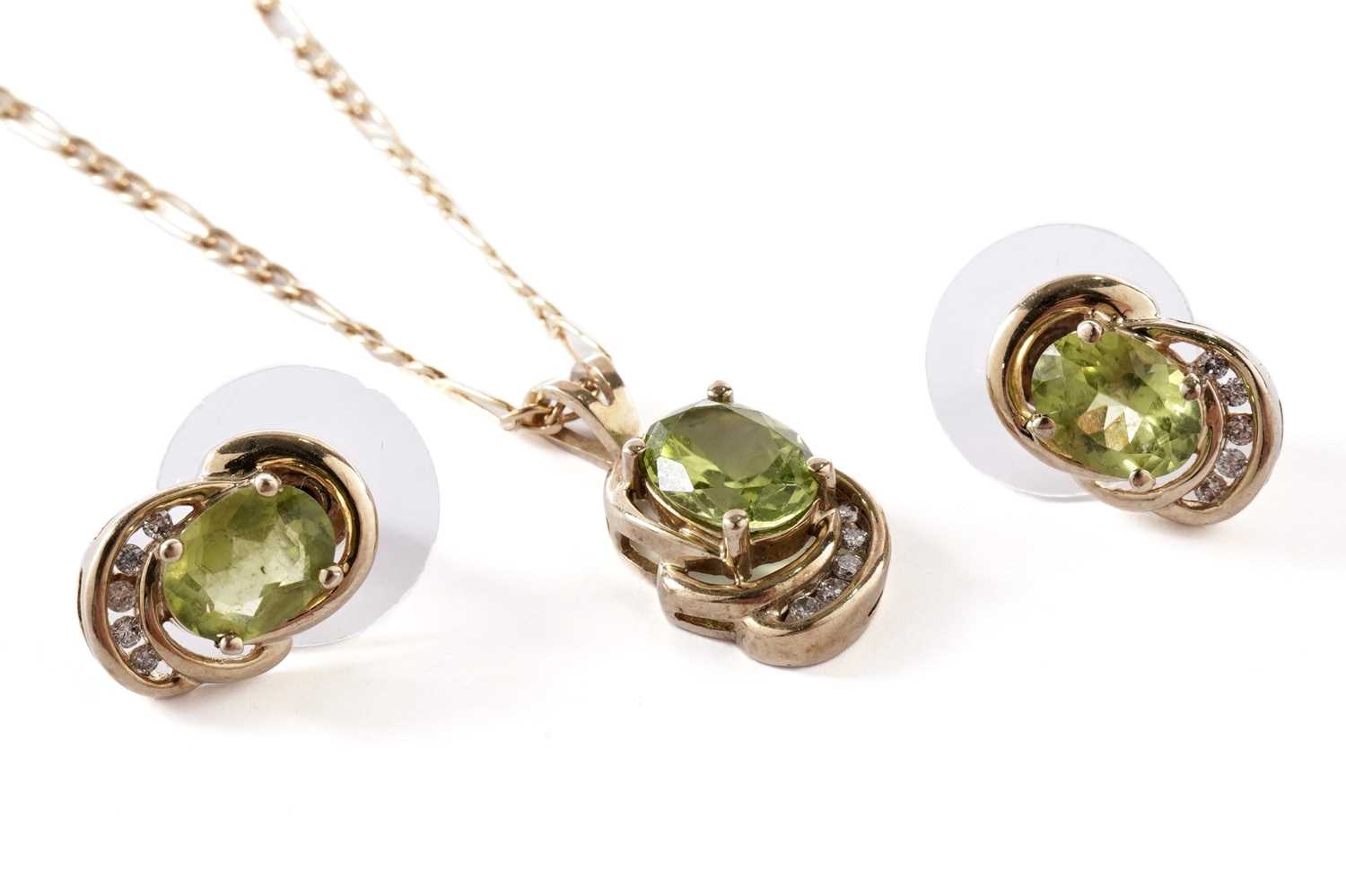 Lot 57 - A peridot and diamond pendant; and a pair of matching earrings