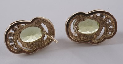 Lot 57 - A peridot and diamond pendant; and a pair of matching earrings