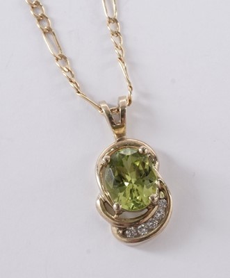 Lot 57 - A peridot and diamond pendant; and a pair of matching earrings