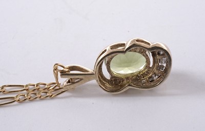 Lot 57 - A peridot and diamond pendant; and a pair of matching earrings