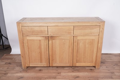 Lot 37 - A contemporary eight-piece oak dining room suite