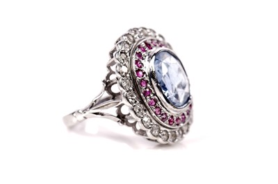 Lot 1119 - A sapphire, ruby, and diamond cluster ring