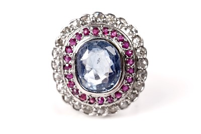 Lot 1119 - A sapphire, ruby, and diamond cluster ring