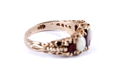 Lot 49 - An opal and garnet five stone ring