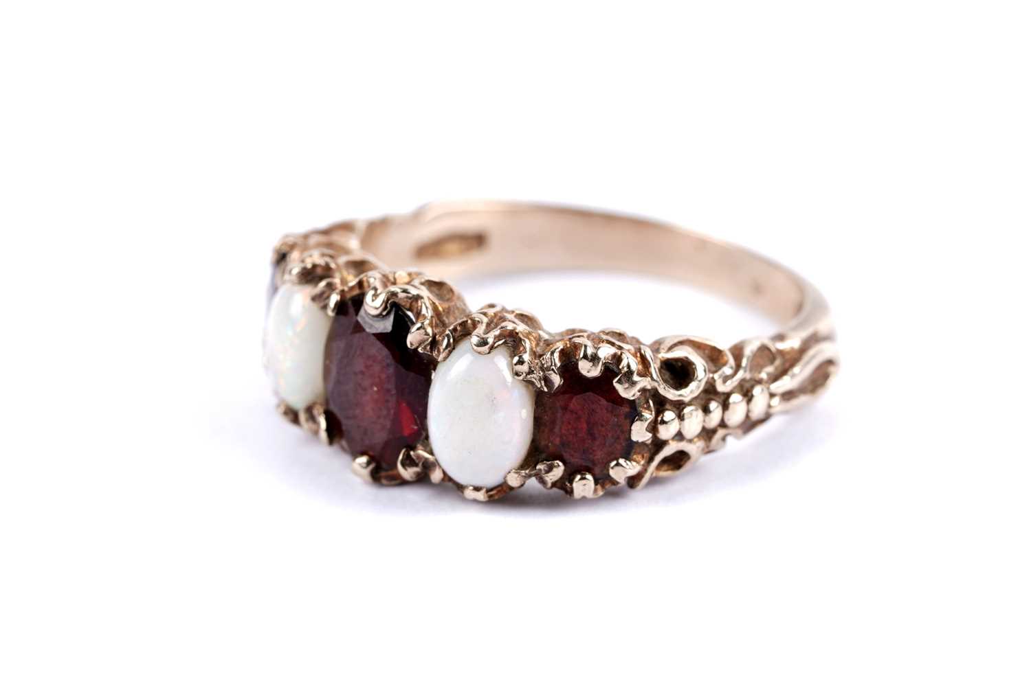 Lot 49 - An opal and garnet five stone ring