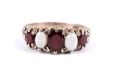 Lot 49 - An opal and garnet five stone ring