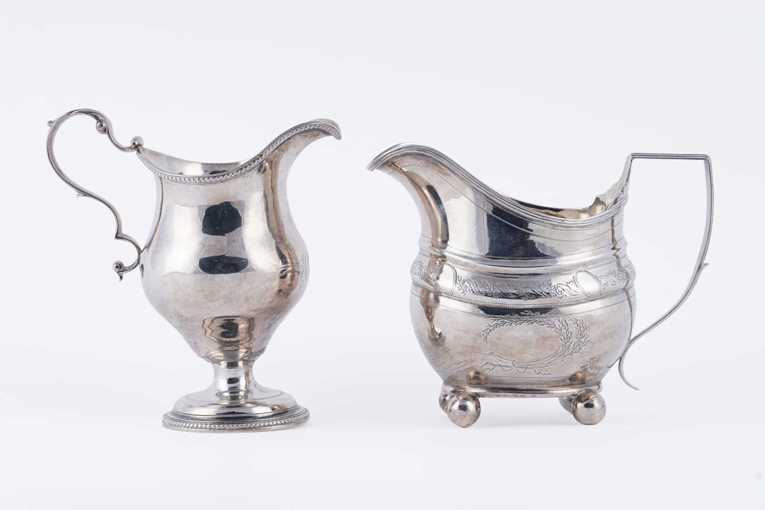 Lot 83 - Two George III silver cream jugs