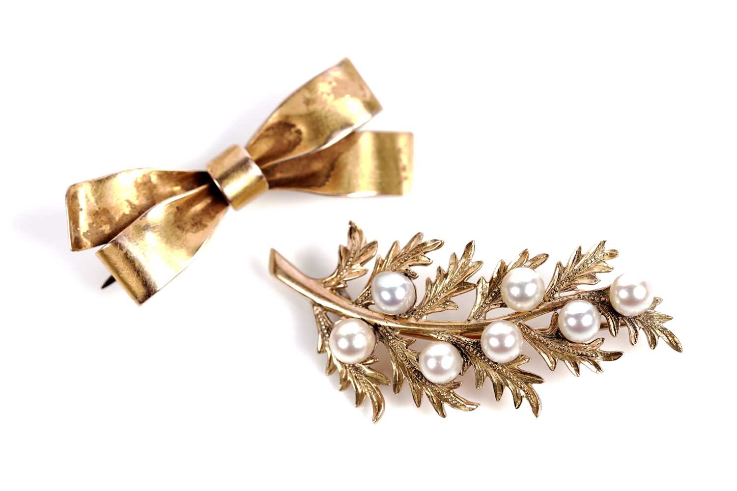 Lot 528 - Two brooches, one in the form of a bow, the other a berried sprig