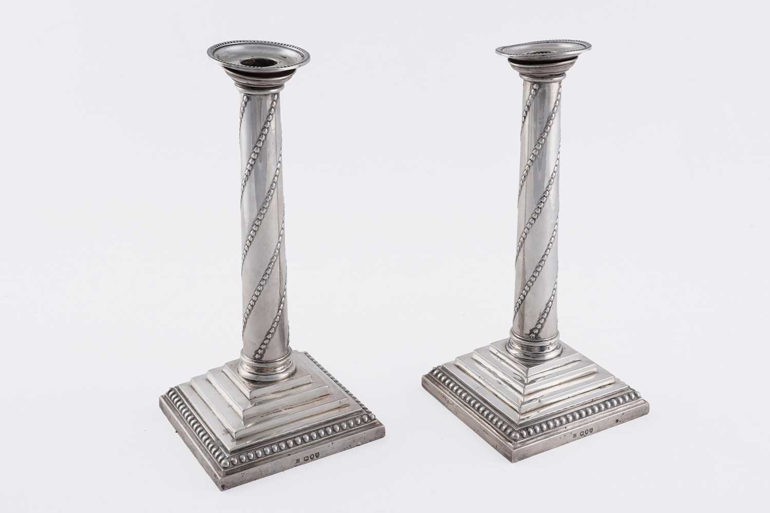 Lot 104 - A pair of late Victorian silver candlesticks