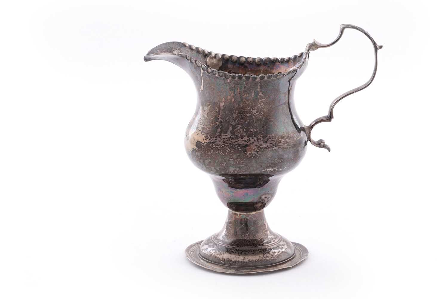 Lot 110 - A George III silver cream jug
