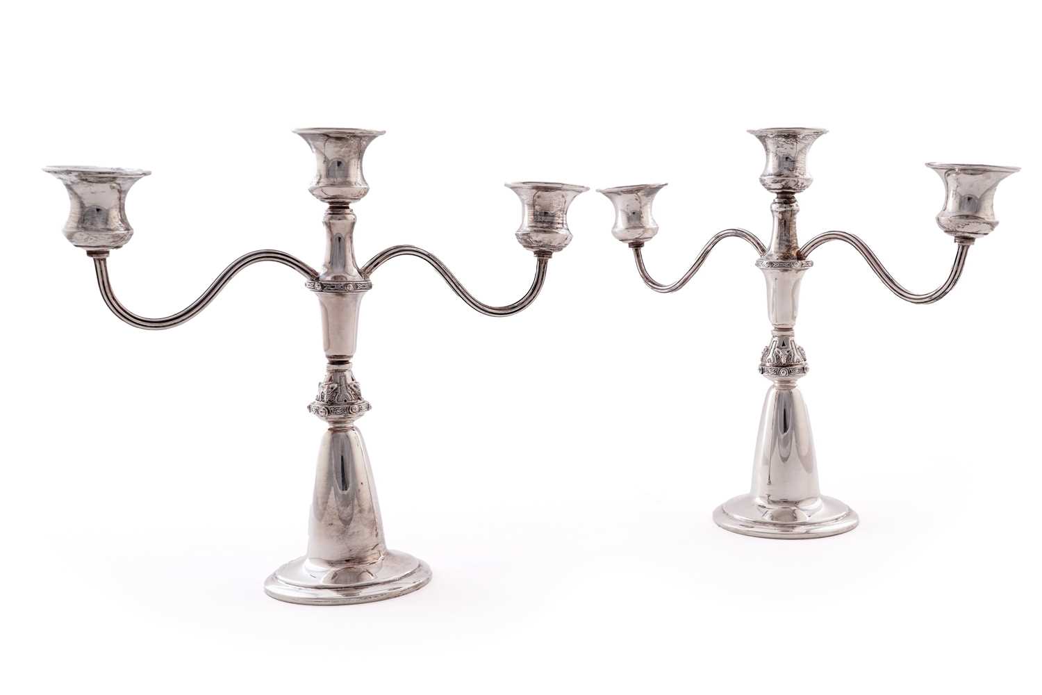 Lot 4 - A pair of Elizabeth II silver three-light candelabra