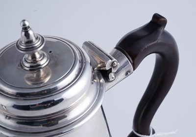 Lot 80 - A George II silver coffee pot of tapering form on a skirted base