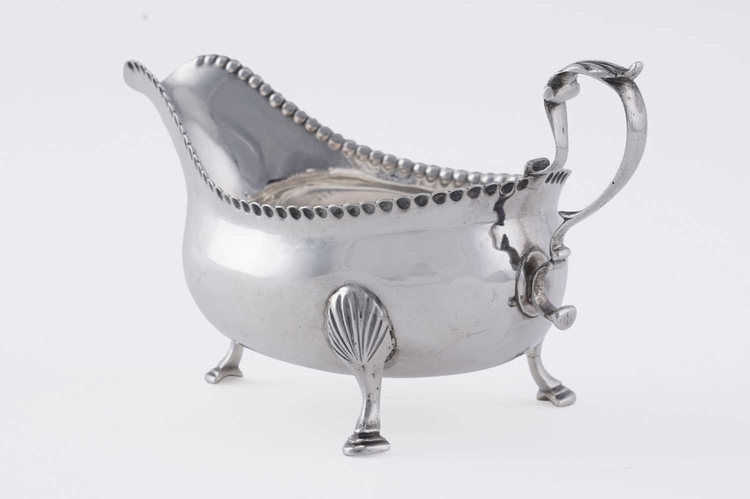 Lot 60 - A George III silver sauceboat on three legs