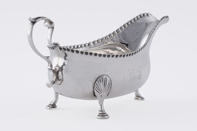 Lot 60 - A George III silver sauceboat on three legs