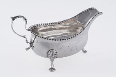 Lot 60 - A George III silver sauceboat on three legs
