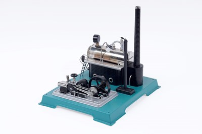 Lot 608 - A Wilesco D-18 stationary tin plate live steam engine; and a ‘Star Yacht’ model pond yacht