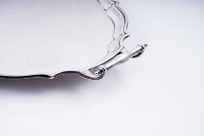 Lot 141 - A George V silver two-handled tray of shaped oval outline