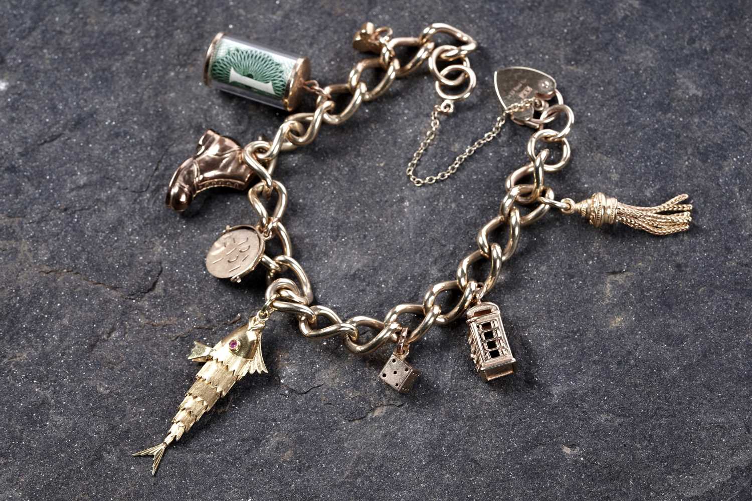 Lot 569 - A 9ct gold curb-link charm bracelet