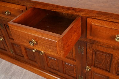 Lot 20 - A contemporary elm three-piece dining room suite