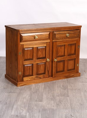 Lot 20 - A contemporary elm three-piece dining room suite