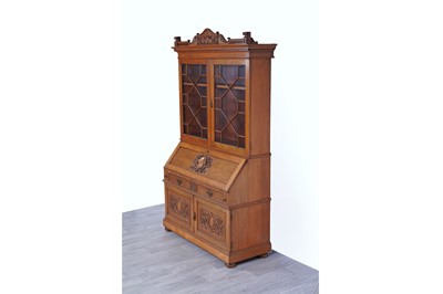Lot 22 - Robson & Sons Newcastle upon Tyne: an early 20th Century carved oak bureau bookcase