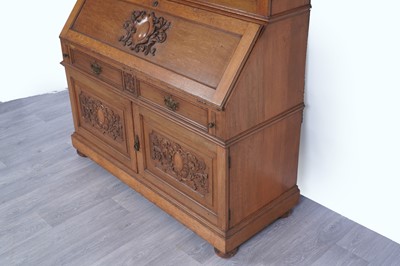 Lot 22 - Robson & Sons Newcastle upon Tyne: an early 20th Century carved oak bureau bookcase