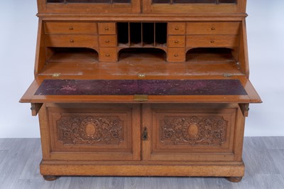 Lot 22 - Robson & Sons Newcastle upon Tyne: an early 20th Century carved oak bureau bookcase