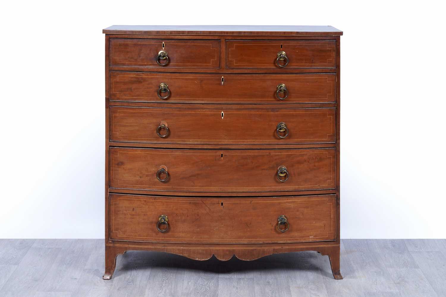 Lot 24 - A George III inlaid mahogany bowfront chest of drawers
