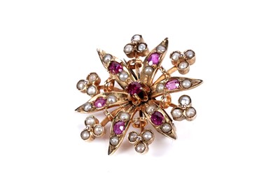 Lot 22 - An Edwardian ruby and split seed pearl brooch