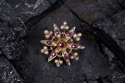 Lot 22 - An Edwardian ruby and split seed pearl brooch